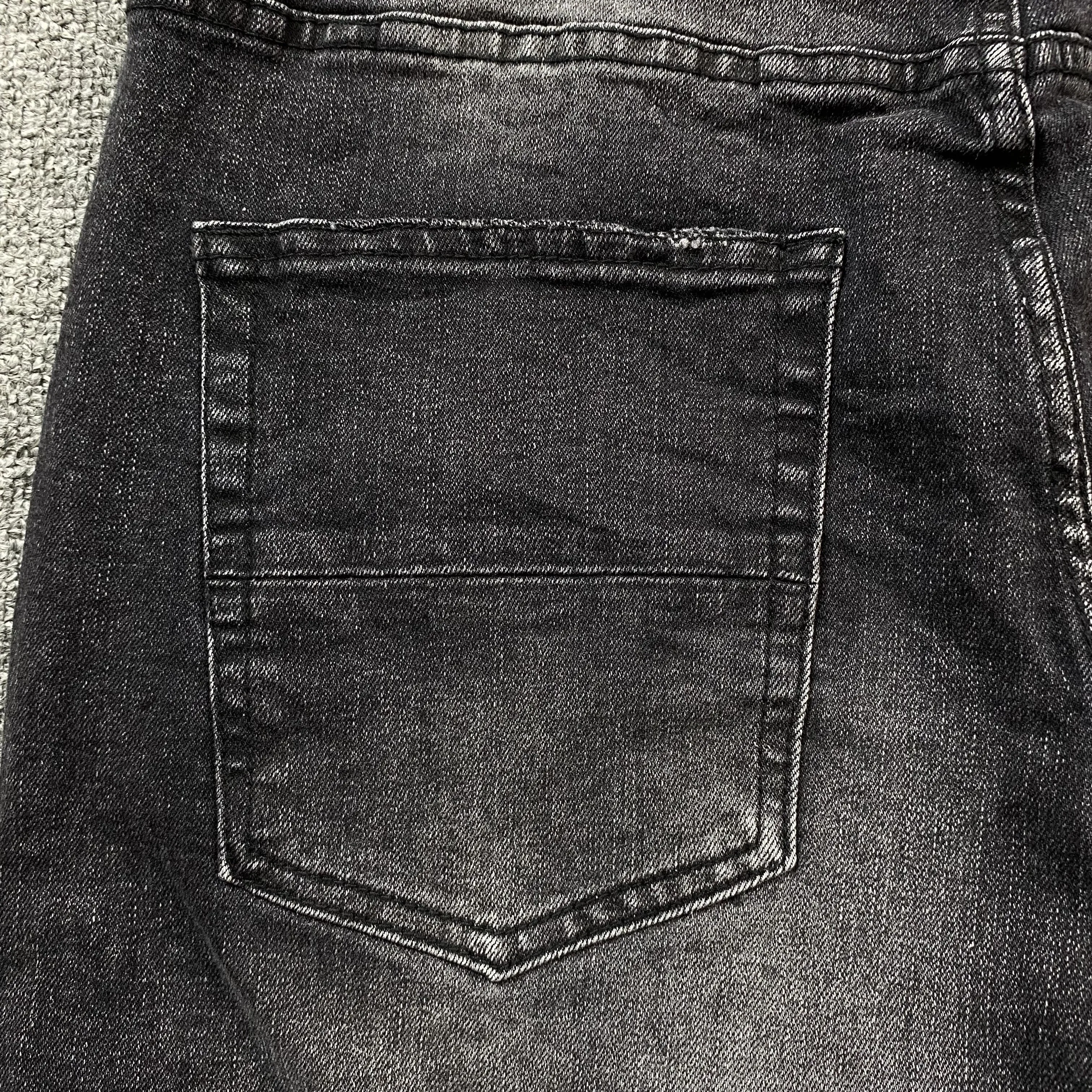 AMIRI VARSITY LOGO REPAIR JEANS