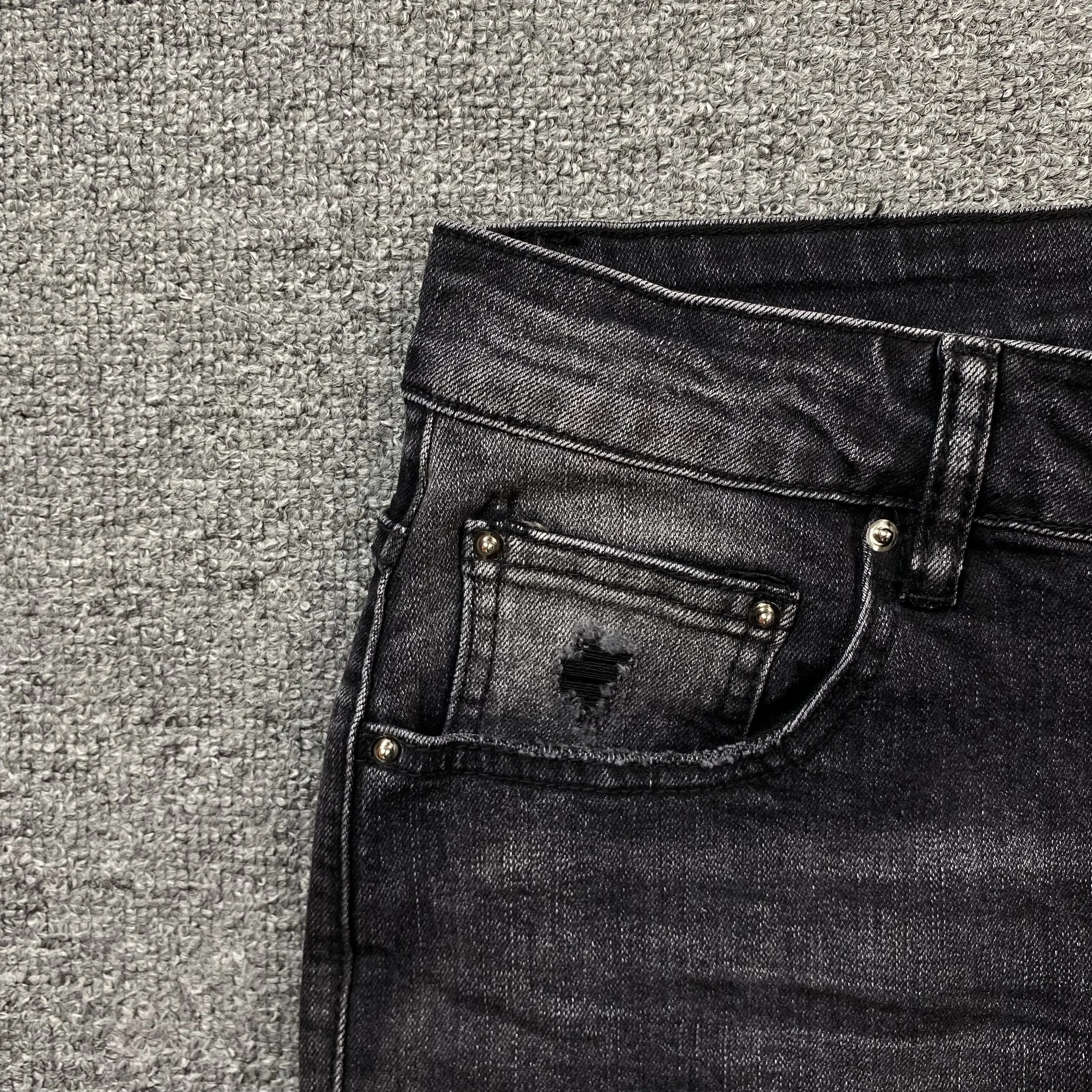 AMIRI VARSITY LOGO REPAIR JEANS